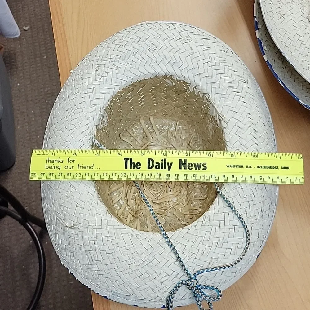 Straw‎ cowboy hat with blue trim.
